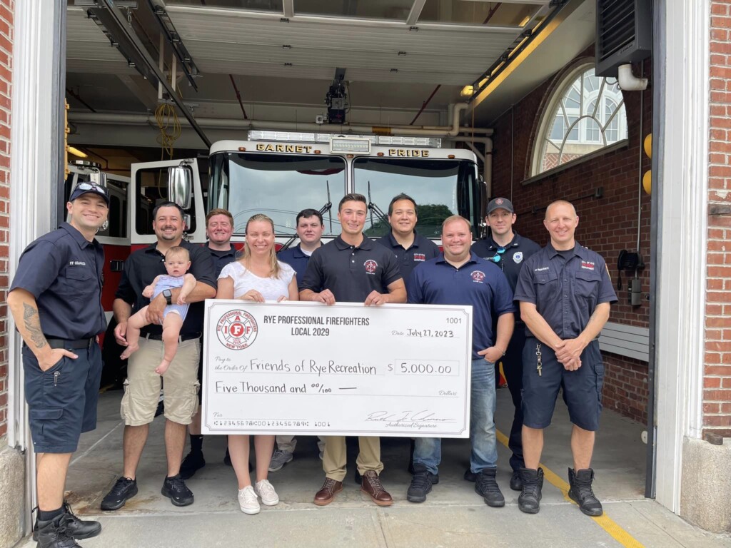 (PHOTO: Rye Professional Firefighters Local 2029 presented $5,000 to Erin Mantz of Friends of Rye Recreation.)