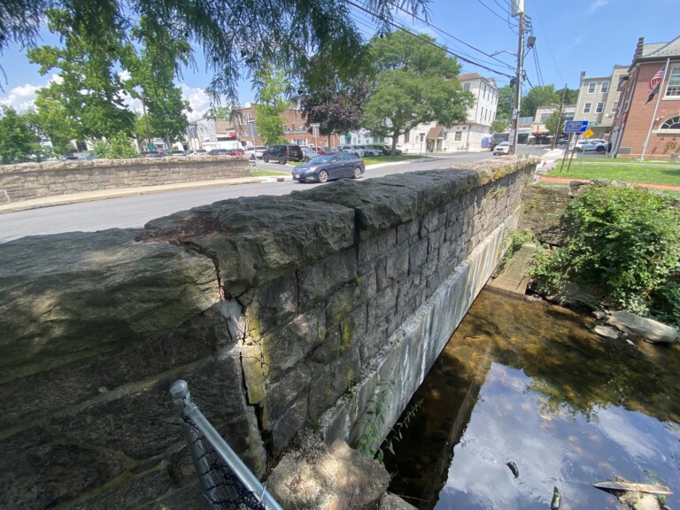 (PHOTO: The Locust Avenue bridge in downtown Rye, New York. Built in 1928, the bridge is expected to be reconstructed in the next couple of years with a combination of state and local funding. The Rye FD firehouse in on the right and downtown Purchase Street is directly ahead at the end of Locust Avenue.)