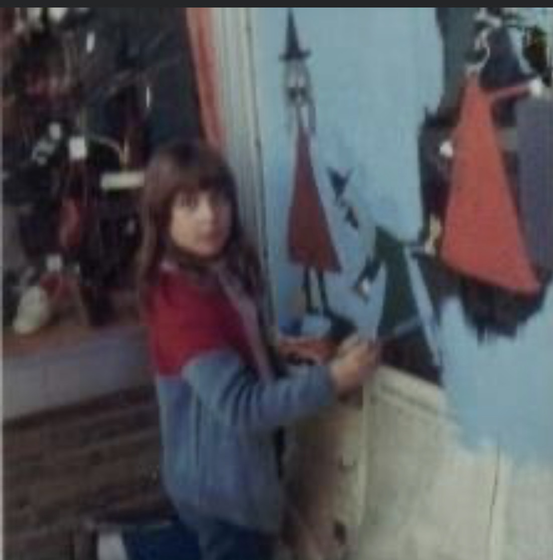 (PHOTO: Lisa Stewart taking part in Rye's annual Halloween Window Painting event in 1966.)
