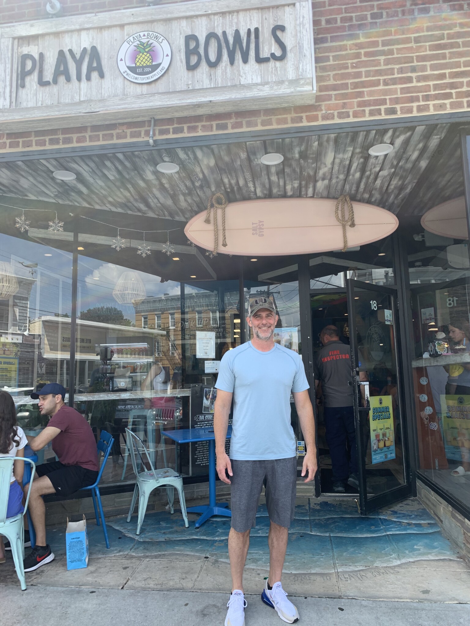 (PHOTO: Owner of Playa Bowls Jarrod Jackette standing outside Playa Bowls in Rye)