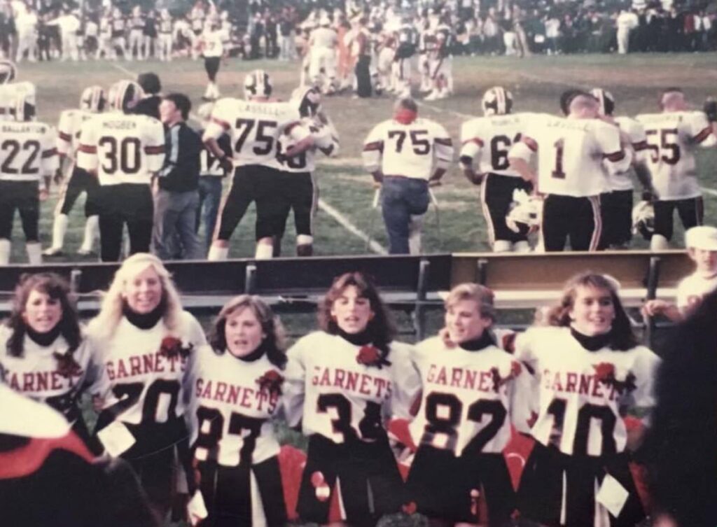 (PHOTO: From left to right- Karen O’Connor, Dawn Dalhgren, Lisa Konrad, Linda Mascali, Kerry Taylor, and Deidre Maloney at Rye Harrison game in 1985.  4 of the 6 still live in Rye and they still get together for the big game!)