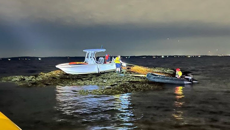 (PHOTO: A Rye FD inflatable rescue boat with Firefighter Ryan Iarocci and Firefighter Cea Fong approaches a boat from the Carefree Boat Club's Rye Boat Basin location with two individuals aboard that ran aground on the rocks off the Shenorock Shore Club on Milton Point on Wednesday, August 23, 2023.)