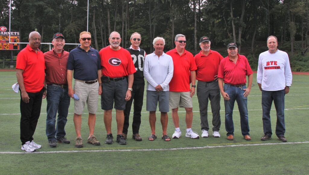 (PHOTO: Talento's brother-in-law, Chris Ley, (third from right) and his football team gathering for the 78th Rye-Harrison Game.)