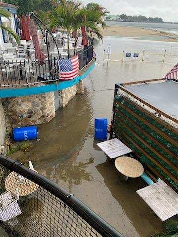 (PHOTO: Rye Town Park did not appear to sustain any visible damage by the water Saturday afternoon has high up on the beach. New sand was put onto the beach earlier in the season. Barley Beach House in on the balcony at the left.)