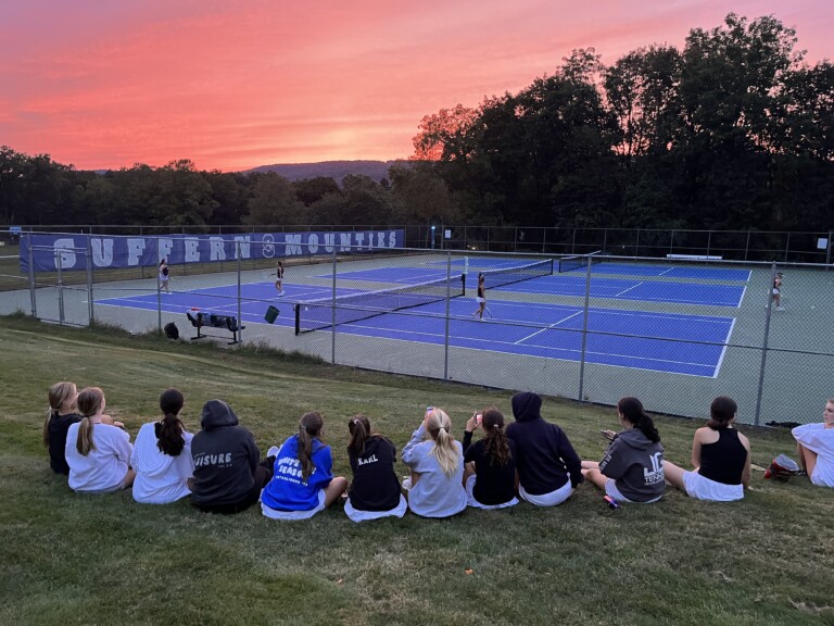 (PHOTO: On Friday the Rye Girls Varsity Tennis team cheers on Tori and Paloma as they come back and get the team win.)