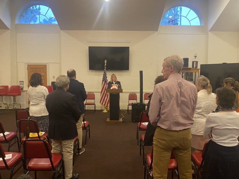 (PHOTO: Reverend and Rye FD Chaplain Andrea Raynor says the blessing at the City of Rye 9-11 Commemoration Ceremony on Monday, September 11, 2023 at the Rye Locust Avenue firehouse.)