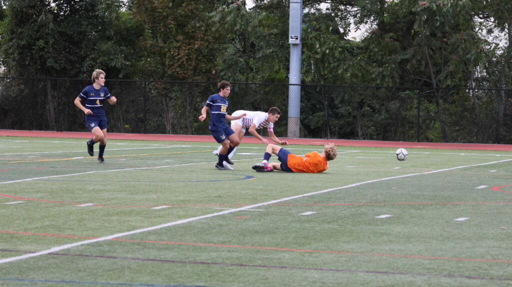 (PHOTO: Rye Boys Varsity Soccer player Tommy Broderick scoring the game winning goal in the 76th minute at Pelham on September 27, 2023. Credit Alvar Lee.)