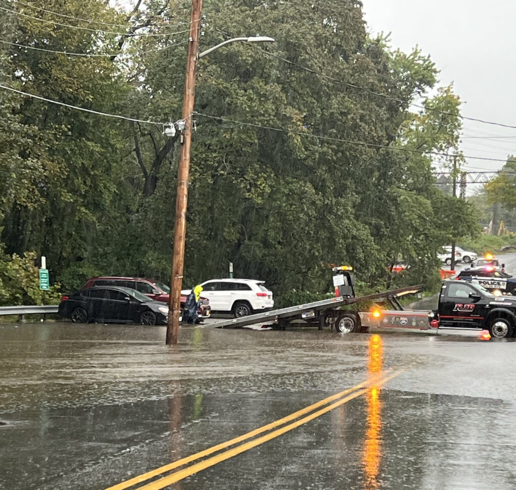 (PHOTO #2: Following the Blind Brook: Theodore Fremd at Elm Street - cars being removed before flooding gets worse on Friday, September 29, 2023.)