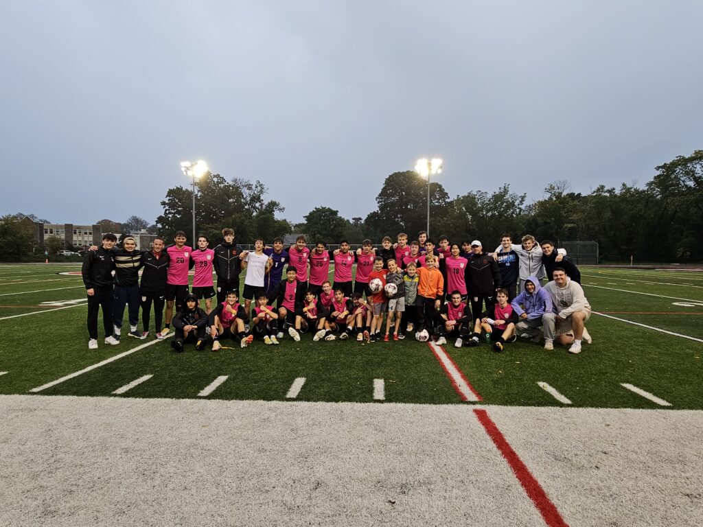 (PHOTO: The squad, ball boys, and alums pose post match. after Saturday's Rye Boys Varsity Soccer game. Credit: Alvar Lee.)