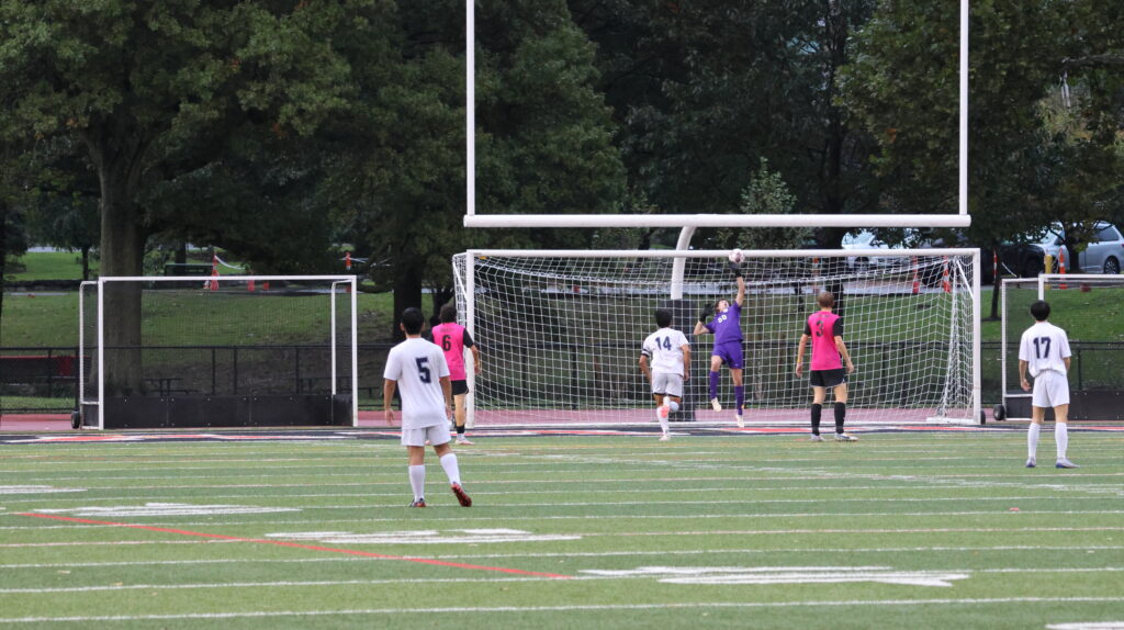 (PHOTO: During Saturday's Rye Boys Varsity Soccer game, Max Crothall goes airborne to make one of seven big-time saves on his way to his most impressive clean sheet of the season. Credit: Alvar Lee.)