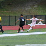 (PHOTO: Alex Lee (#18) goes in for a tackle during the Rye Boys Varsity Soccer game at Edgemont on Tuesday, October 3, 2023. Credit: Alvar Lee.)