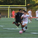 (PHOTO: Alex Rojas (#24) drives forward with the ball during the Rye Boys Varsity Soccer game at Edgemont on Tuesday, October 3, 2023. Credit: Alvar Lee.)