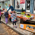 (PHOTO: Children’s Philanthropy of Rye volunteer Kendall Truman assists with treat selection at the annual Halloween window paints event on October 22, 2023.)