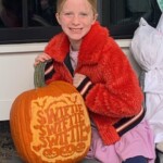 (PHOTO: Nina Orr was the lucky raffle winner of the coveted “Swiftie” pumpkin at the annual Halloween window paints event on October 22, 2023.)