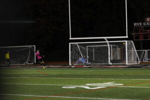 (PHOTO: Rye Boys Varsity Soccer Lex Cox clinches the win by converting in the fourth round of penalties.)