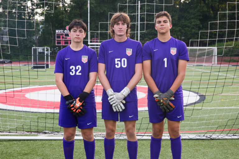 (PHOTO: Rye Boys Varsity Soccer goalies #32 Martin Fields, #50 Max Crothall, and #1 Aydan Breen have all seen action over the past four matches, with the three goalkeepers combining to allow only one goal in the past 280 minutes. Credit: Aileen Brown.)