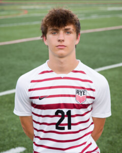 (PHOTO: Rye Boys Varsity Soccer player #21 Fin Kearney scored Rye's fourth goal in the 72nd minute. Credit: Aileen Brown.)