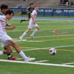 (PHOTO: At Rye Boys Varsity Soccer on Saturday versus Yorktown, Kaden Zion crossed the ball while Peter Wilmot looked on. Credit: Alvar Lee.)