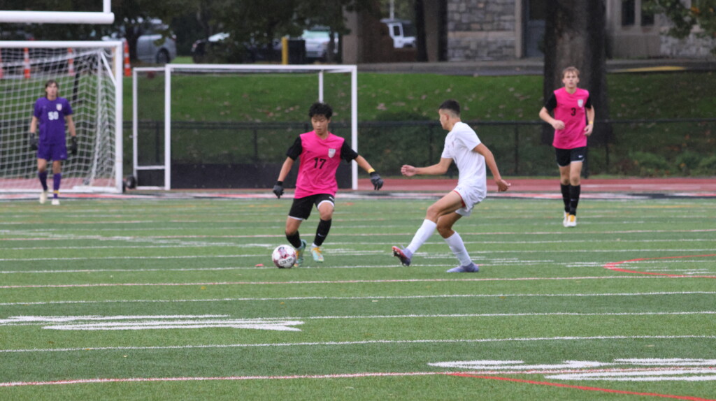 (PHOTO: Rye Boys Varsity Soccer player Shun Nagata controls the ball. Credit: Alvar Lee.)