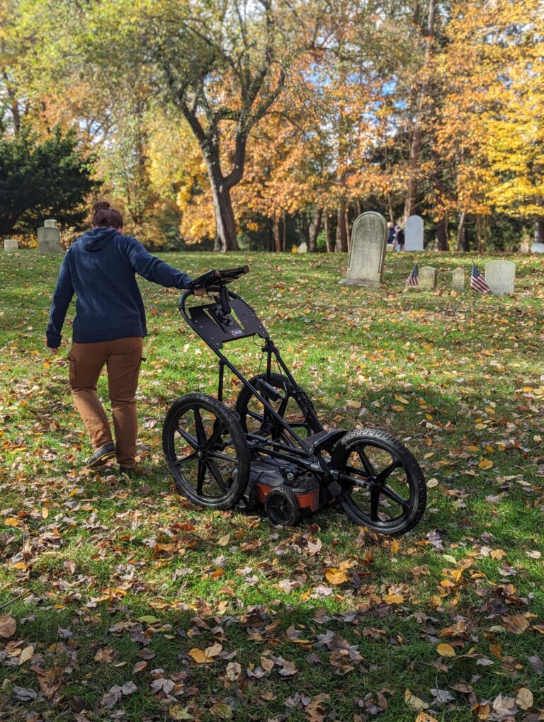 (PHOTO: Heritage Consultants uses what looks like a high tech baby stroller to map the underground at Rye's African American Cemetery.)