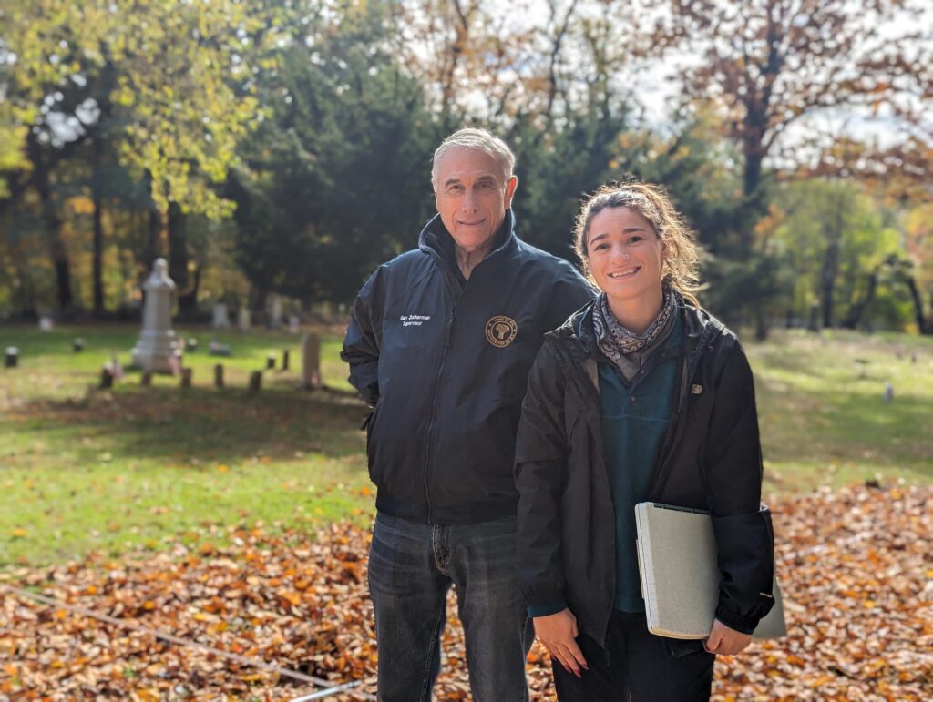 (PHOTO: Town of Rye Supervisor Gary Zuckerman with Brenna Pisanelli, senior project manager for Heritage Consultants at Rye's African American Cemetery.)