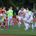 (PHOTO: The Rye Boys Varsity Soccer squad celebrates after Tommy Broderick extended the lead to 3-0 in the 44th minute at Edgemont on Tuesday, October 3, 2023. Credit: Alvar Lee.)