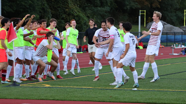 (PHOTO: The Rye Boys Varsity Soccer squad celebrates after Tommy Broderick extended the lead to 3-0 in the 44th minute at Edgemont on Tuesday, October 3, 2023. Credit: Alvar Lee.)
