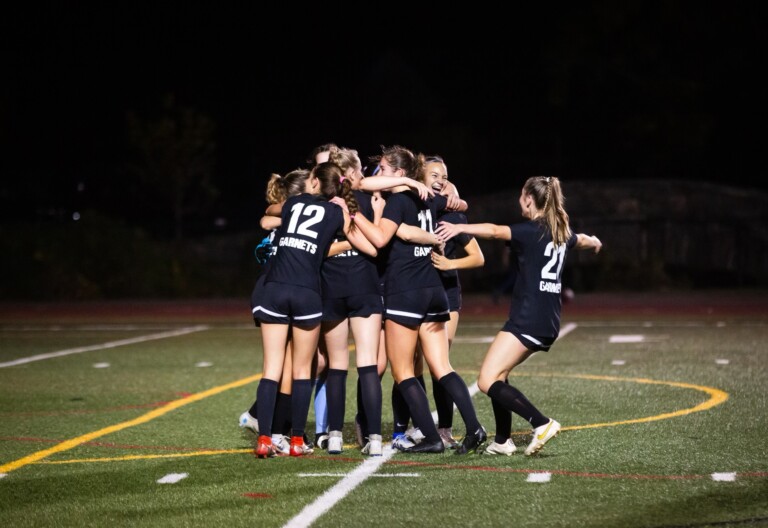 (PHOTO: Rye Girls Varsity Soccer waded across John Jay Cross River on Tuesday. Credit: Aileen Brown.)