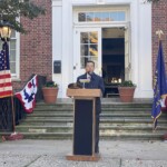 (PHOTO: Rye Mayor Josh Cohn delivers remarks during the Veterans Day ceremony on the Rye Village Green November 11, 2023.)