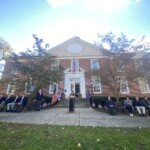 (PHOTO: Robin Latimer sings God Bless America at the Veterans Day ceremony on the Rye Village Green November 11, 2023.)