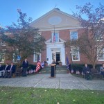 (PHOTO: Robin Latimer sings God Bless America at the Veterans Day ceremony on the Rye Village Green November 11, 2023.)