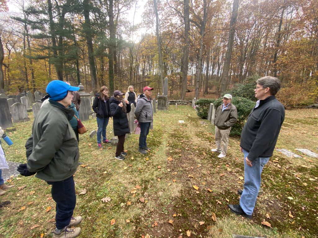 (PHOTO: Jay Cemetery Association President Peter Doane speaks with local residents about the site's history on Veterans Day 2023.)