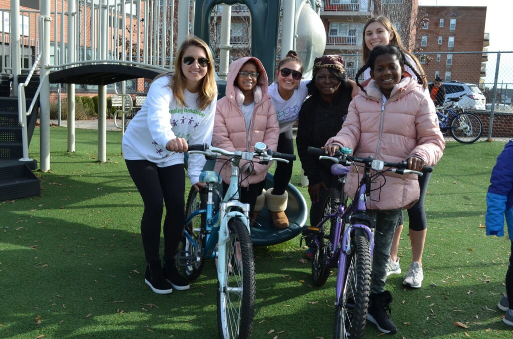 (PHOTO: Linking Handlebars bike giveaway at Carver Center in Port Chester with Lucia Villani, Cristiana Villani and Julia Bateman.)