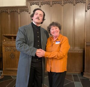 (PHOTO: Marie Johnson with Edgar Allen Poe at a recent reading at Rye Presbyterian Church.)