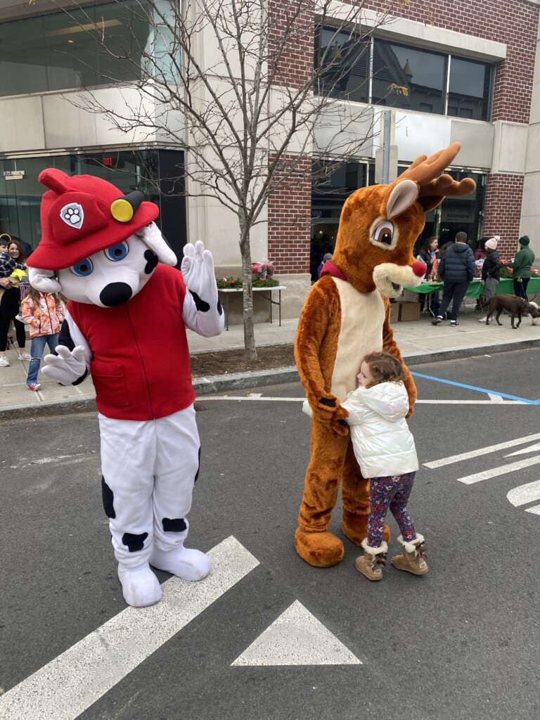 (PHOTO: A firedog and a reindeer at Mistletoe Magic on Purchase Street in Rye on Sunday, November 26, 2023.)