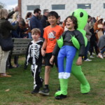 (PHOTO: Osborn Elementary School students assembling for their parade onto The Osborn retirement community campus on October 31, 2023 to celebrate Halloween.)