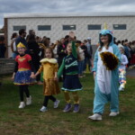 (PHOTO: Osborn Elementary School students assembling for their parade onto The Osborn retirement community campus on October 31, 2023 to celebrate Halloween.)