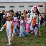 (PHOTO: Osborn Elementary School students assembling for their parade onto The Osborn retirement community campus on October 31, 2023 to celebrate Halloween.)