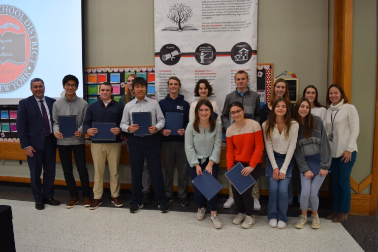 (PHOTO: Rye Recognition of Excellence awards were given to the Rye High School seniors who were named National Merit Semi-Finalists and Commended Students at the Board of Ed meeting on November 14, 2023. Back row, left to right: Dr. Eric Byrne, Dan Yamaguchi (Semi-Finalist), Paddy Harrigan (Semi-Finalist), Spencer Swiader (Commended Student), Jiawen Hao (Commended Student), Bryan Laverty (Commended Student), Polina Komarova (Commended Student), Niklas Hofmann (Commended Student), Juliette Hamlen (Commended Student), Amelia Brooks (Commended Student) Principal Suzanne Short. Front row, left to right: Kiki Keith (Commended Student), Lara Oktay (Commended Student), Rebecca Speas (Commended Student), and Samantha Ryan (Commended Student).)