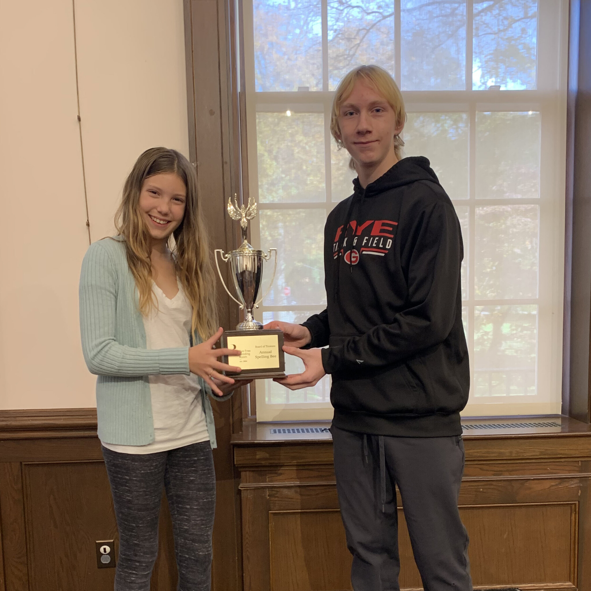 (PHOTO: The W-I-N-N-E-R-S (PHOTO: 7th grade victor Emma Crozier and 10th grade victor Calvin Holler at the 6th Annual Spelling Bee on November 11, 2023.)