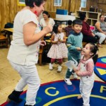 (PHOTO: Dancing fun with 5 Steps to Five Teacher Irma Arellano with Nathan and Nicole at All Souls Community Center in Port Chester during Summer 2023.)