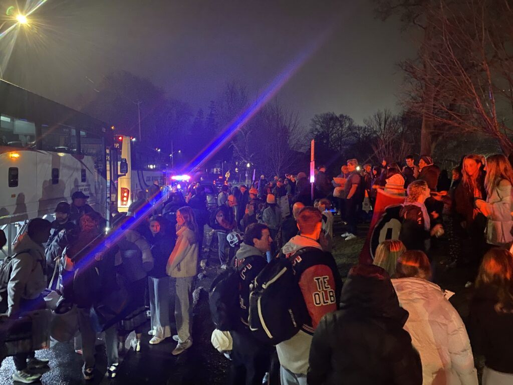 (PHOTO: Rye Garnet Football was welcomed back with a PD and FD escort to Rye High School Sunday evening after winning the State Finals in Syracuse, New York.)