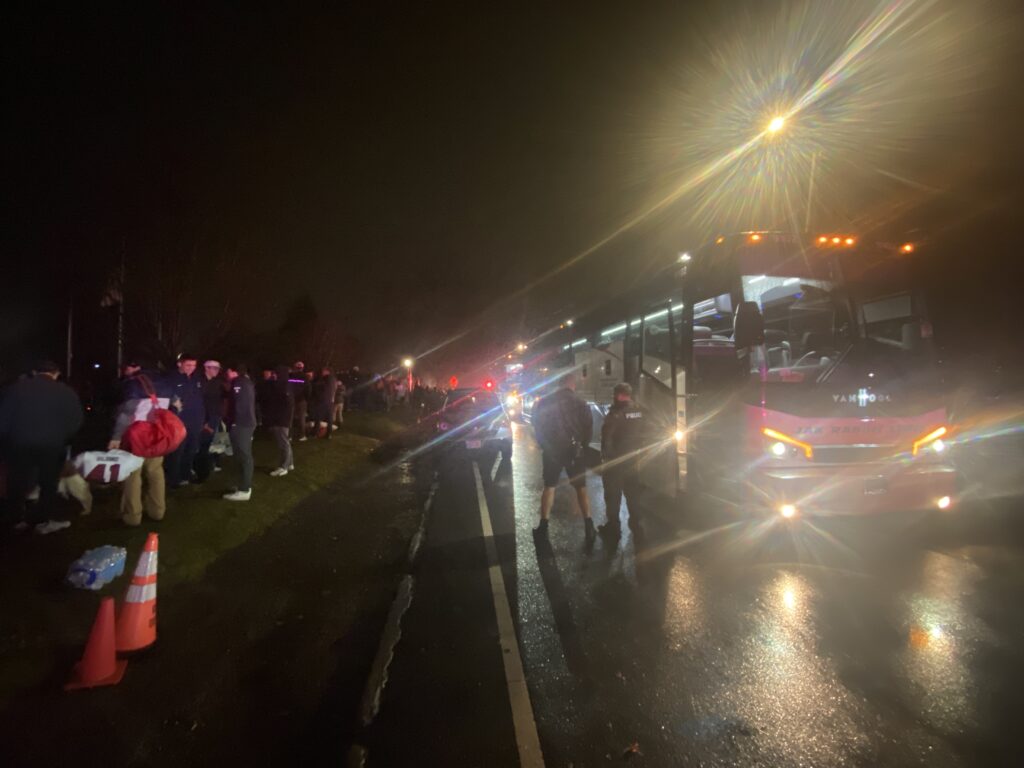 (PHOTO: Rye Garnet Football was welcomed back with a PD and FD escort to Rye High School Sunday evening after winning the State Finals in Syracuse, New York.)