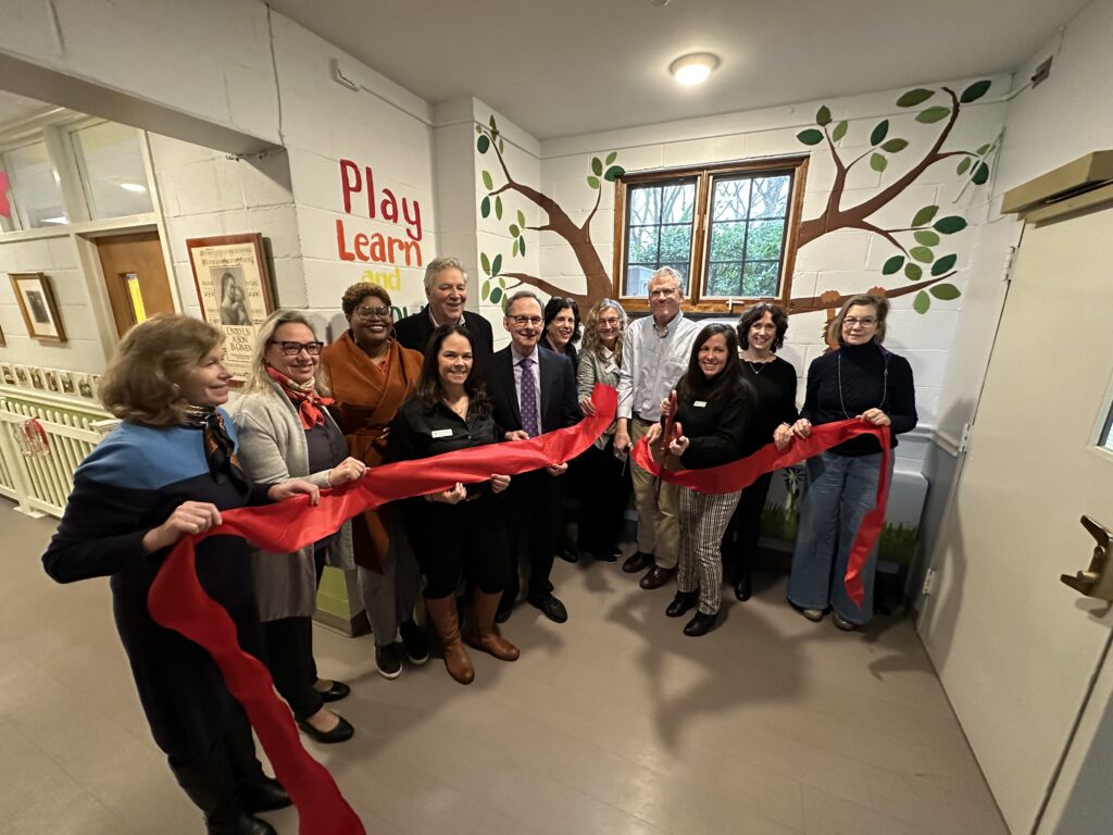 (PHOTO: The ribbon cutting in January 2023 for the Rye YMCA's nursery School in Mamaroneck. Kathy Lynam, senior program director is holding the scissors. To her left is Jon Elsen who was board president at the time, and Sabrina Murphy, CEO.)