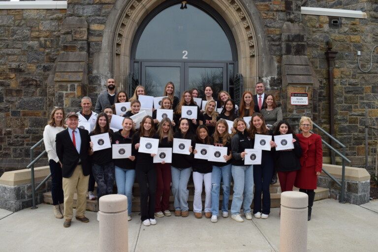 (PHOTO: The champion Rye High School Girls Varsity Soccer team received New York State Assembly proclamations on Thursday, December 14, 2023. Photo shows (most of) the team, Coach Rich Savage, Assistant Coach Giuliana Addesso, Superintendent Dr. Byrne, Principal Suzanne Short, Athletic Director Susan Reid Dullea, and Al Mercado, Assistant to the Athletic Program, along with State Senator Shelley Mayer and State Representative Steve Otis.)