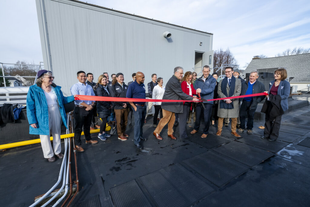 (PHOTO: A "boiler house" in the sky - officials from the Rye YMCA, FEMA, local government and contracting companies gather for the ribbon cutting of the Rye YMCA's new rooftop boiler room.) 
