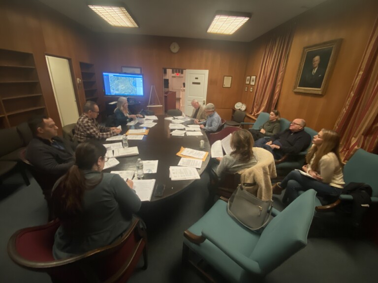 (PHOTO: The City of Rye Planning Commission in deliberations on Wainwright House's event approval on Tuesday evening in the Mayor's conference room in City Hall. Along the right wall are Wainwright board members (L to R) Kelly Jancski, Bob Manheimer and Lexy Tomaino.)