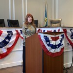 (PHOTO: Robin Latimer sings God Bless America at the City of Rye Inauguration Ceremony on Monday, January 1, 2024.)