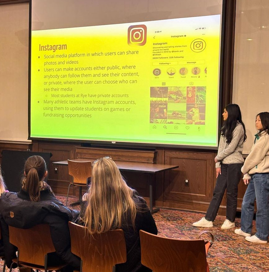 (PHOTO: Rye High School senior Paulina Tepan, winner of the 2023 Rye Youth Human Rights Award (left), with Grace Wang (right) giving our annual Inside School Social Media Presentation to share insight with middle school parents.)