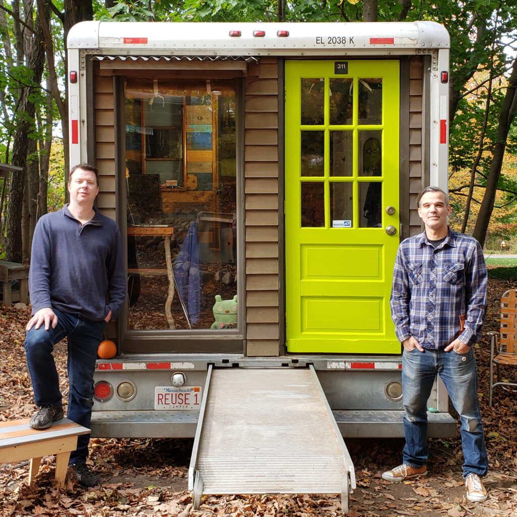 (PHOTO: Former HGTV host and tiny house designer Derek Deek Diedricksen and filmmaker and reuse expert Alex Eaves with their REUSE! Box Truck tiny home.)